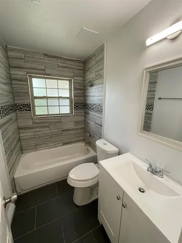 a bathroom with a sink toilet bathtub and vanity