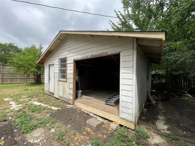 a view of backyard of house with green space