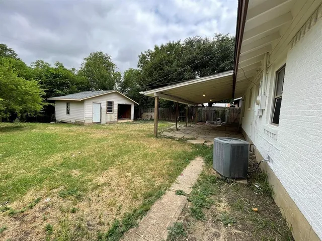 a view of a house with backyard sitting area and garden