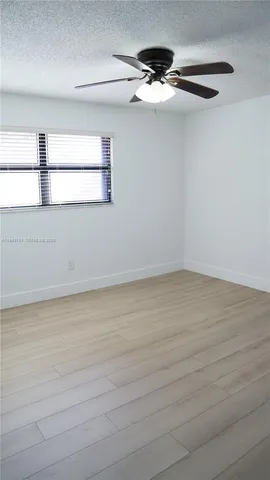 an empty room with wooden floor