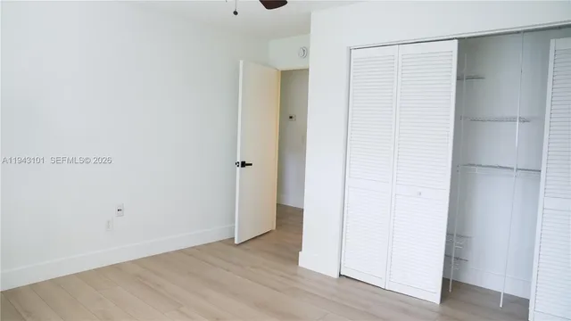 a white toilet sitting next to a shower