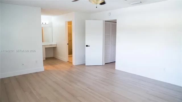 a bedroom with a bed and a mirror