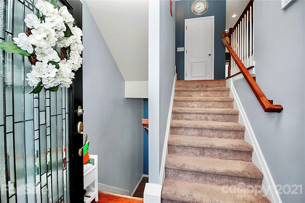110 Layla Drive Tega Cay, SC 29708 - Photo 22 of 35 a view of staircase with white walls and wooden floor