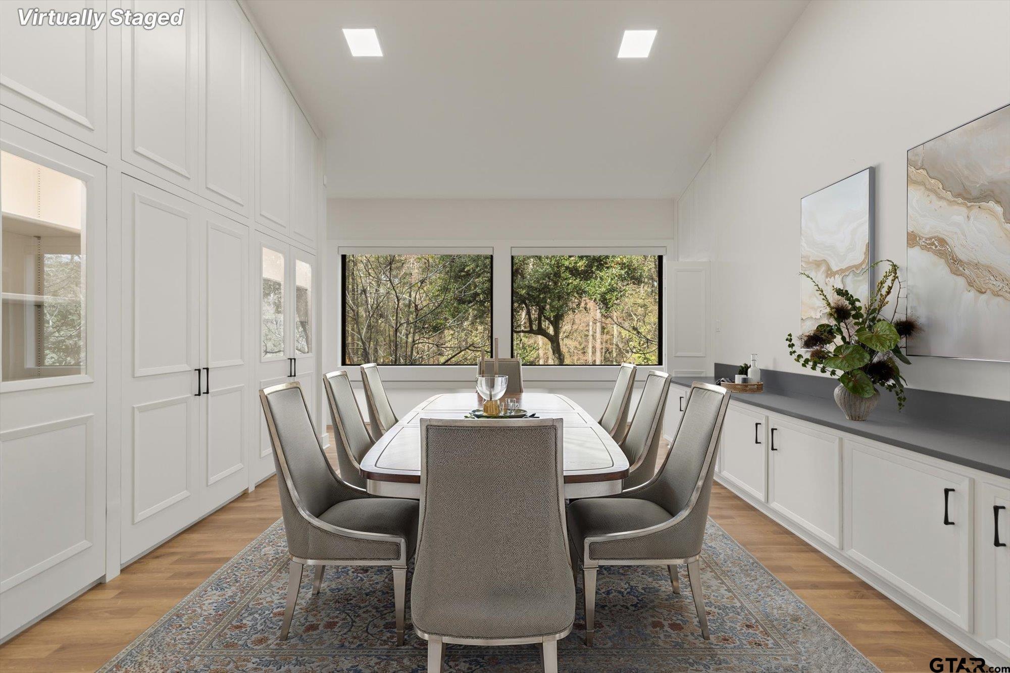 6376 Tryon Road Longview, TX 75605 - Photo 14 of 43 a dining room with furniture potted plants and wooden floor