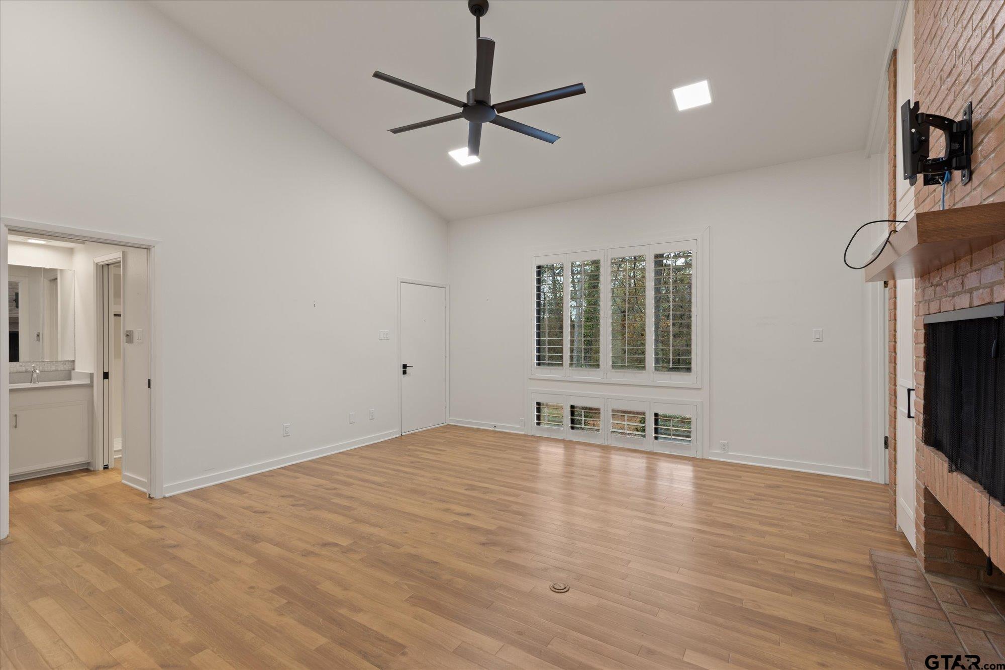 6376 Tryon Road Longview, TX 75605 - Photo 25 of 43 a view of an empty room with a window and wooden floor
