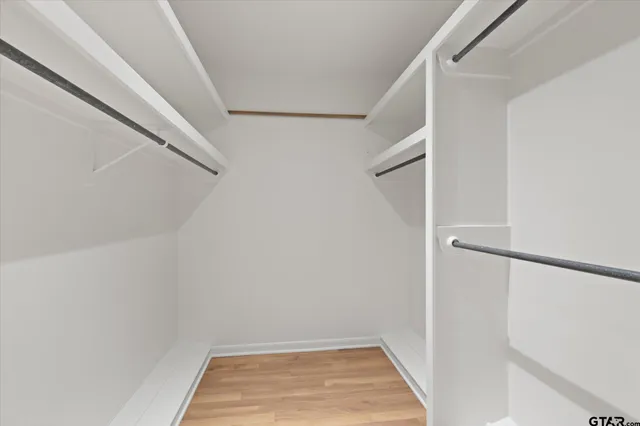 a view of an empty room and wooden floor