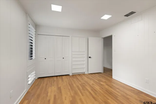 a room with wooden floor and bathroom
