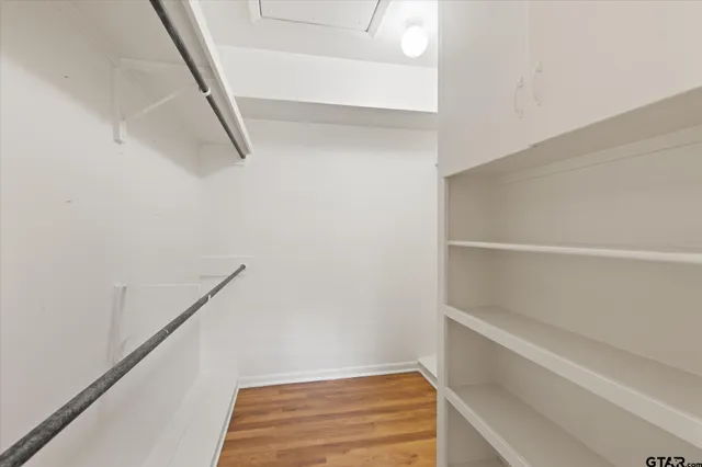a view of kitchen with stainless steel appliances cabinets and wooden floor