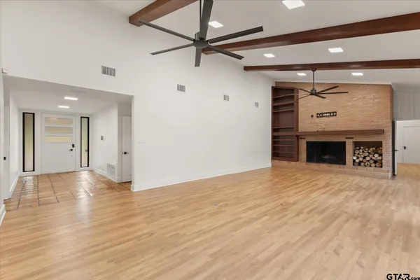 a living room with fireplace furniture and a large window