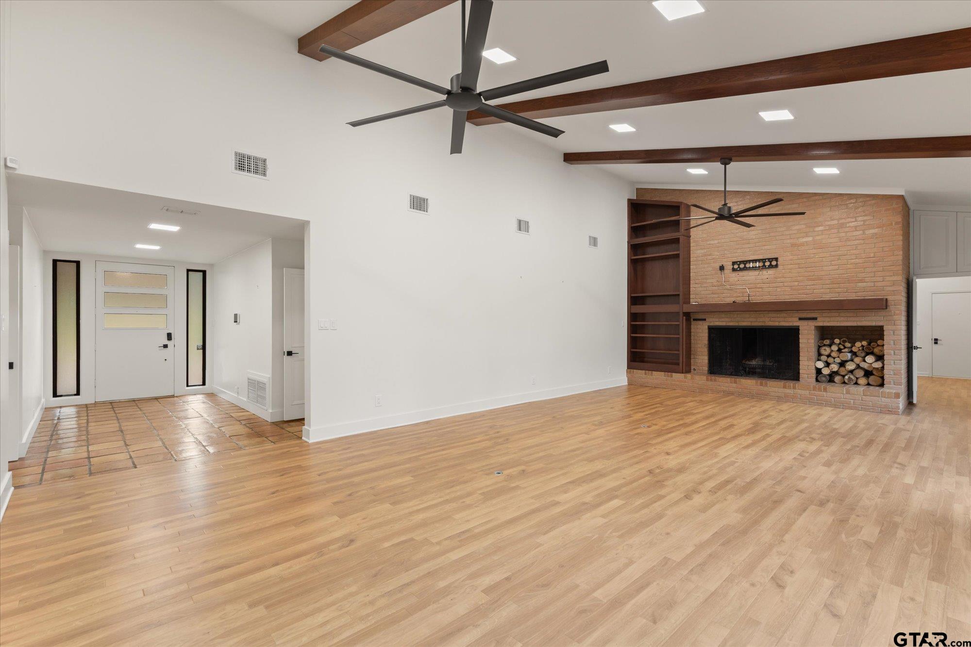 6376 Tryon Road Longview, TX 75605 - Photo 6 of 43 a view of an empty room with a fireplace and a ceiling fan