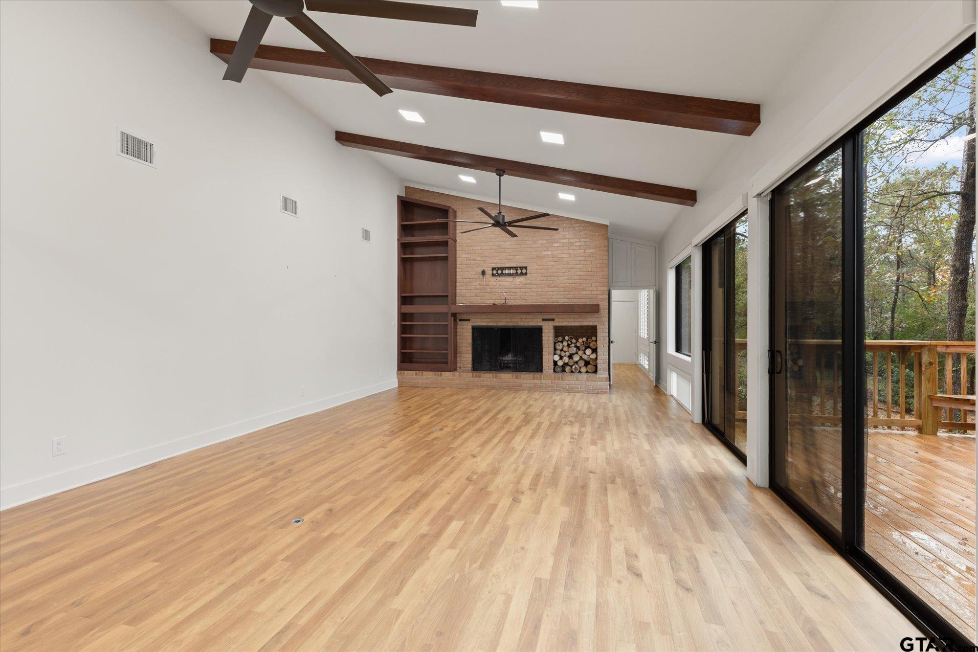 6376 Tryon Road Longview, TX 75605 - Photo 8 of 43 a view of empty room with wooden floor and fireplace