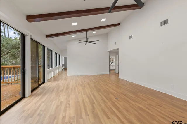 a kitchen with stainless steel appliances a sink a stove and a wooden cabinets