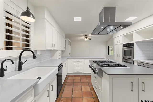 a kitchen with stainless steel appliances a stove and a refrigerator