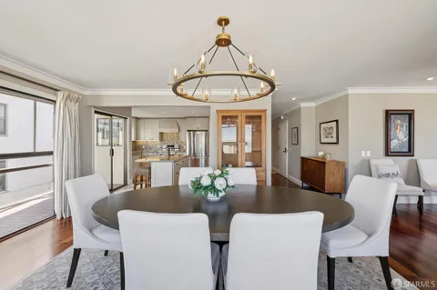 a kitchen with white cabinets stainless steel appliances and a window