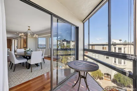 a view of a dining room with furniture wooden floor and chandelier