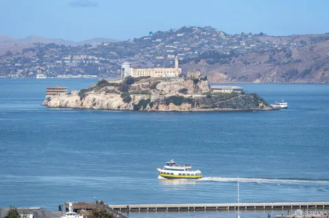 a kitchen with stainless steel appliances kitchen island granite countertop a refrigerator and a stove top oven