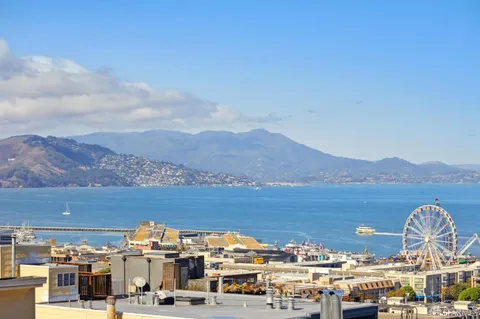 a kitchen with granite countertop a refrigerator and a stove top oven