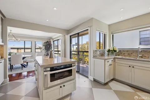 a bathroom with a granite countertop toilet sink and mirror