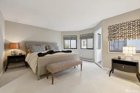 a balcony with wooden floor and city view