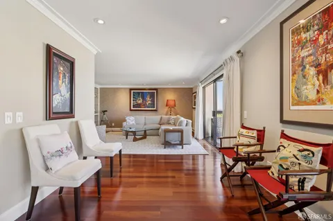 a living room with fireplace furniture and a large window