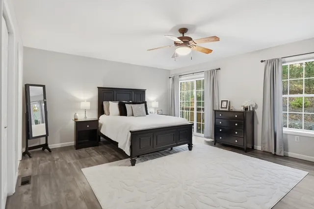 a bedroom with a large bed and a chandelier