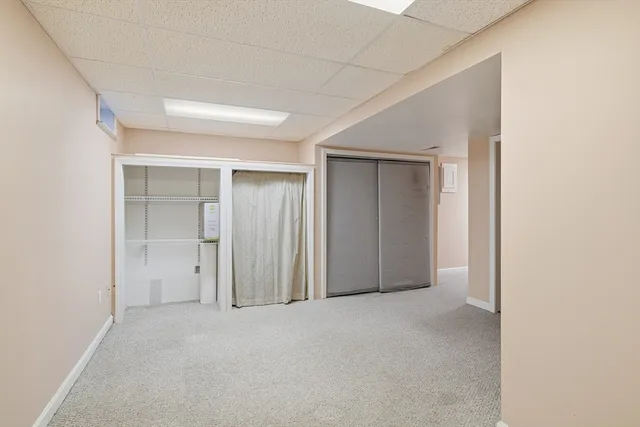 a view of a house with a yard and wooden fence