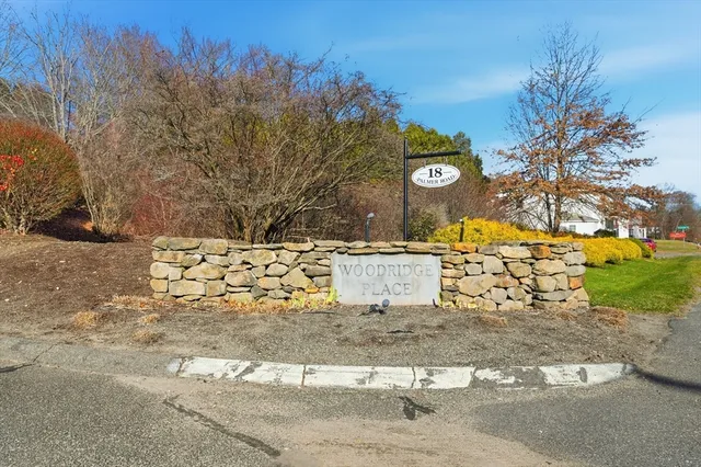 a view of a house with wooden wall and a large window