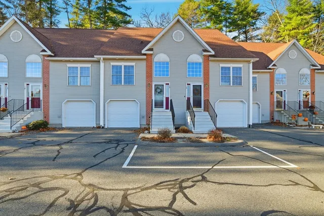 a view of a house with a swimming pool and sitting area