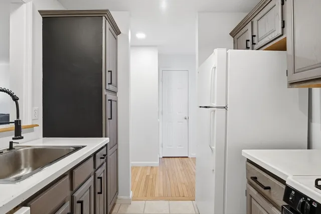 a kitchen with a sink and a refrigerator