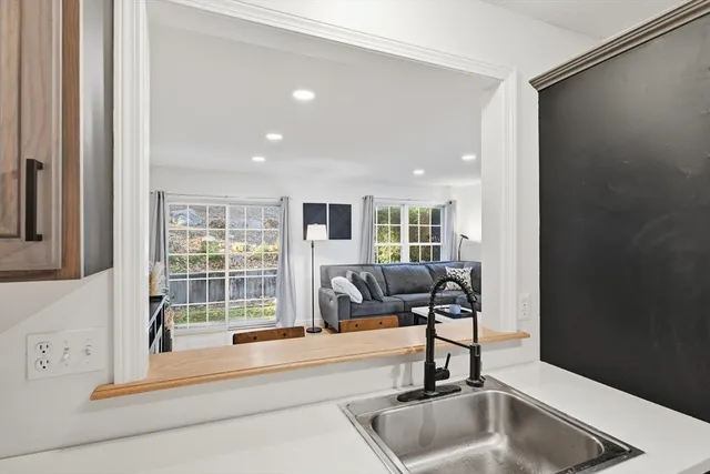 a kitchen with a sink and a large window