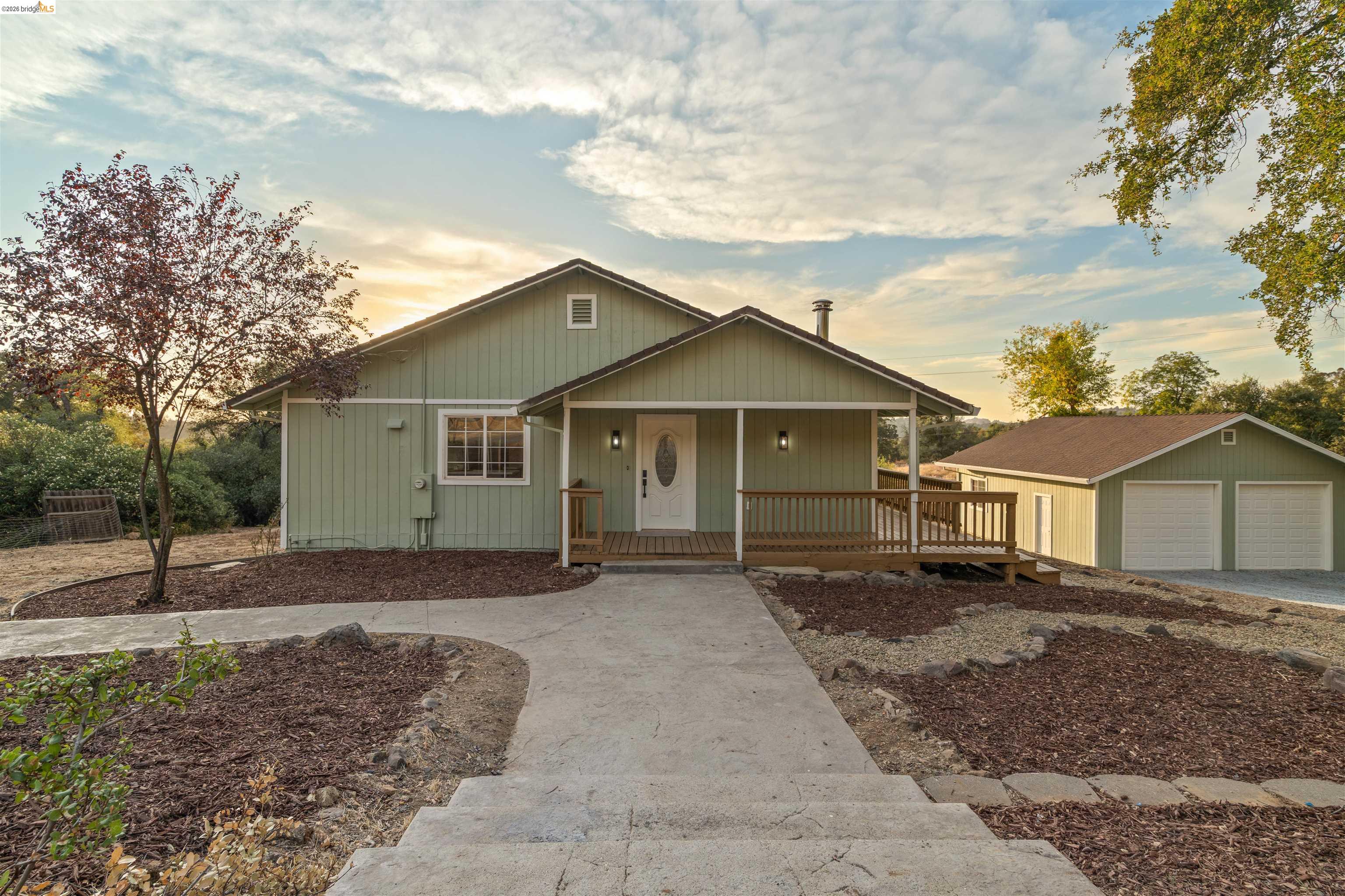 19676 Rawhide Road Sonora, CA 95370 - Photo 7 of 67 Light green exterior with a covered porch and front deck