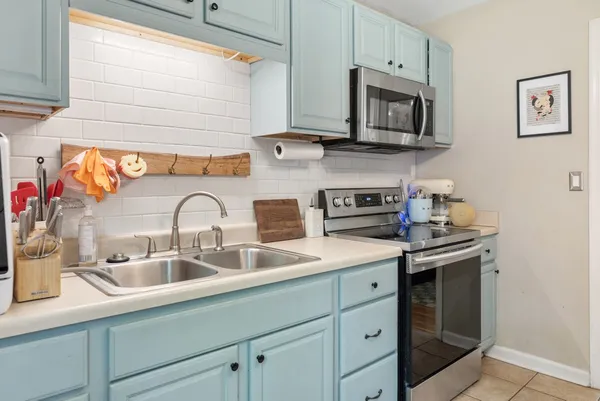 a kitchen with stainless steel appliances granite countertop a sink and a stove