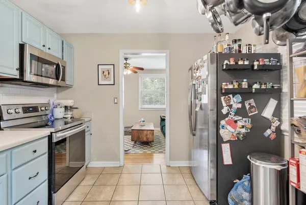 a kitchen with stainless steel appliances granite countertop a refrigerator and a stove