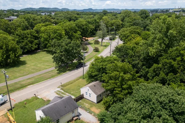 an aerial view of a house with yard swimming pool and lake view