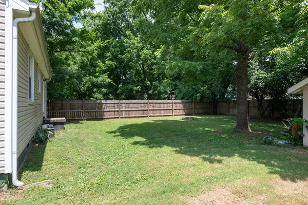 a view of backyard with trampoline