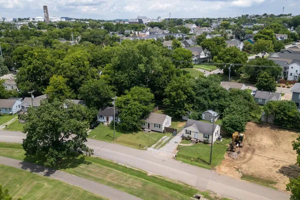 an aerial view of a house with garden space and trees