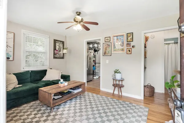 a living room with furniture and wooden floor