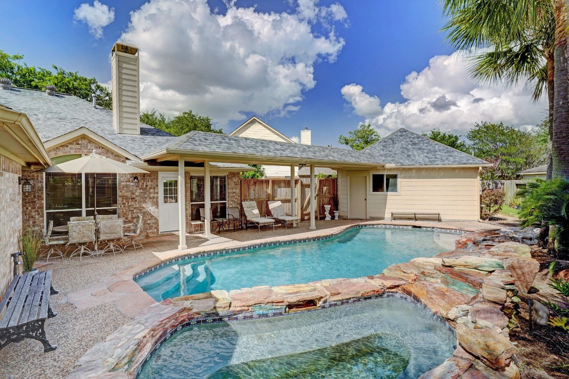 5307 Summerland Ridge Court Houston, TX 77041 - Photo 30 of 35 Back of the home showing covered and uncovered patios, pool and heated spa.