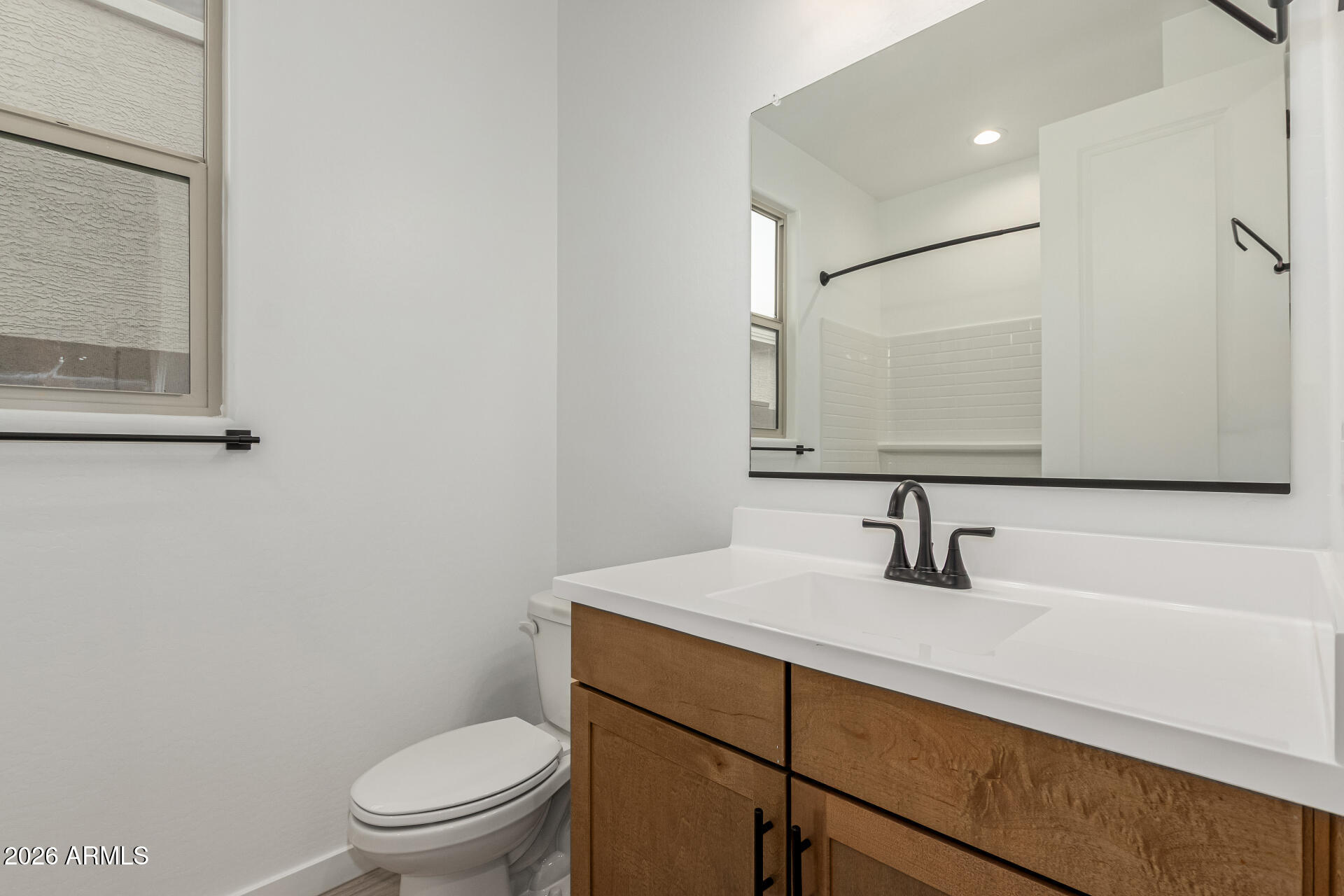 8029 West Granada Road Phoenix, AZ 85035 - Photo 11 of 35 a bathroom with a toilet sink and mirror