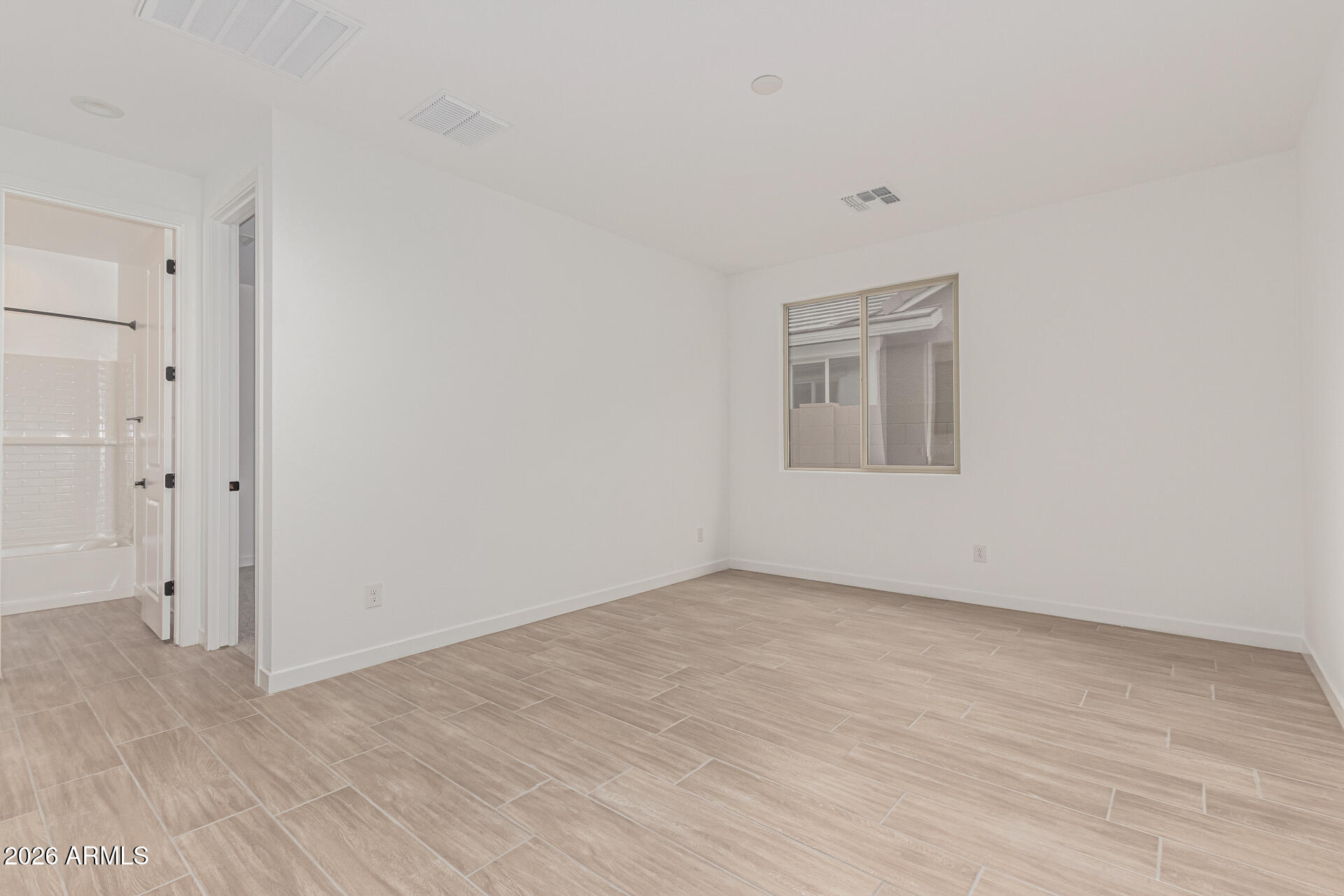 8029 West Granada Road Phoenix, AZ 85035 - Photo 15 of 35 a view of an empty room with wooden floor and a window
