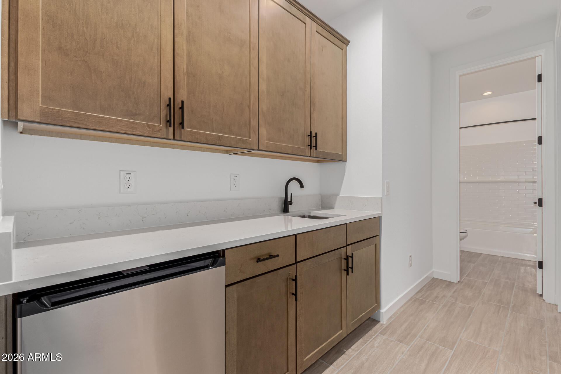 8029 West Granada Road Phoenix, AZ 85035 - Photo 17 of 35 a kitchen with white cabinets and a sink