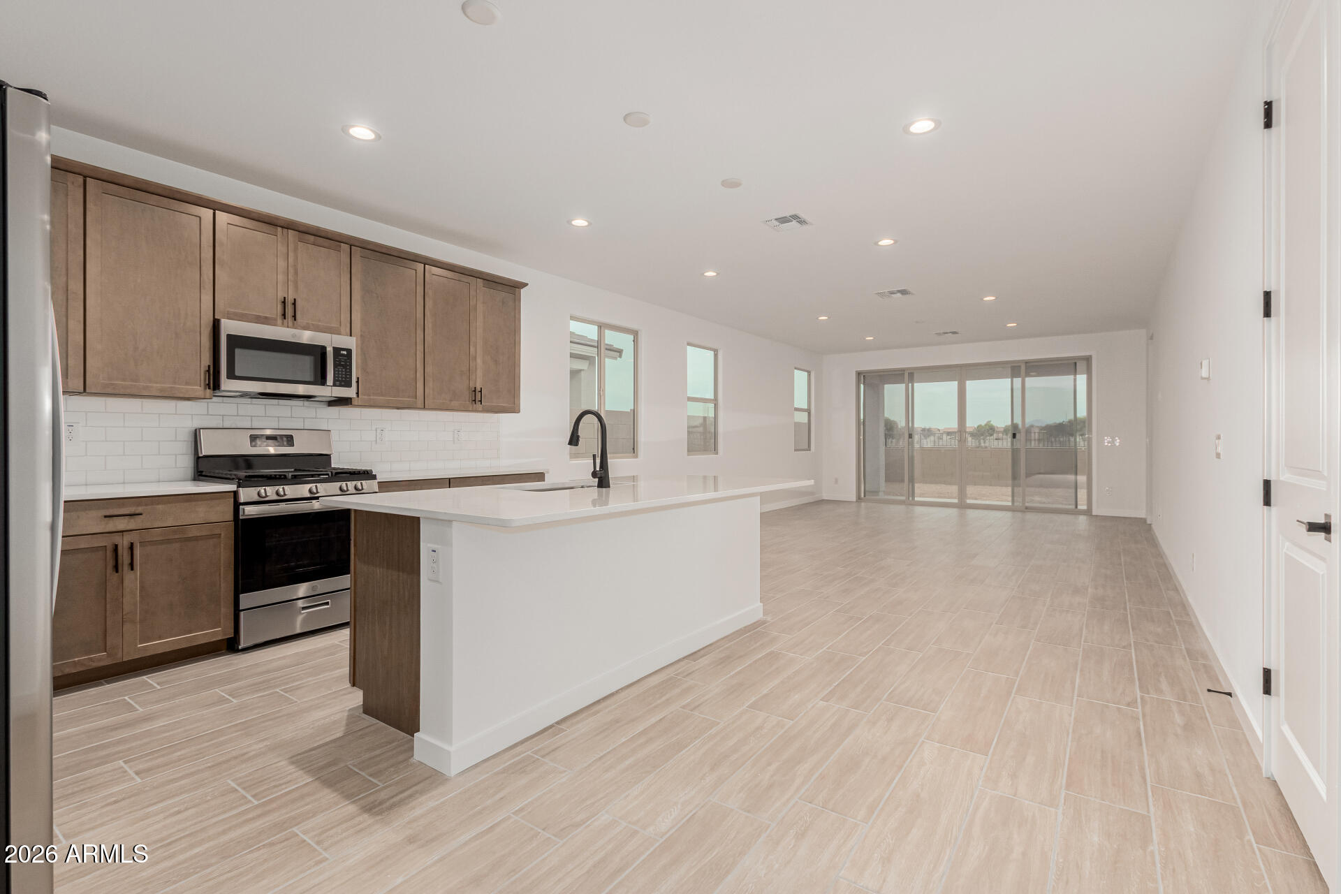 8029 West Granada Road Phoenix, AZ 85035 - Photo 2 of 35 a kitchen with stainless steel appliances granite countertop a stove a sink and a refrigerator