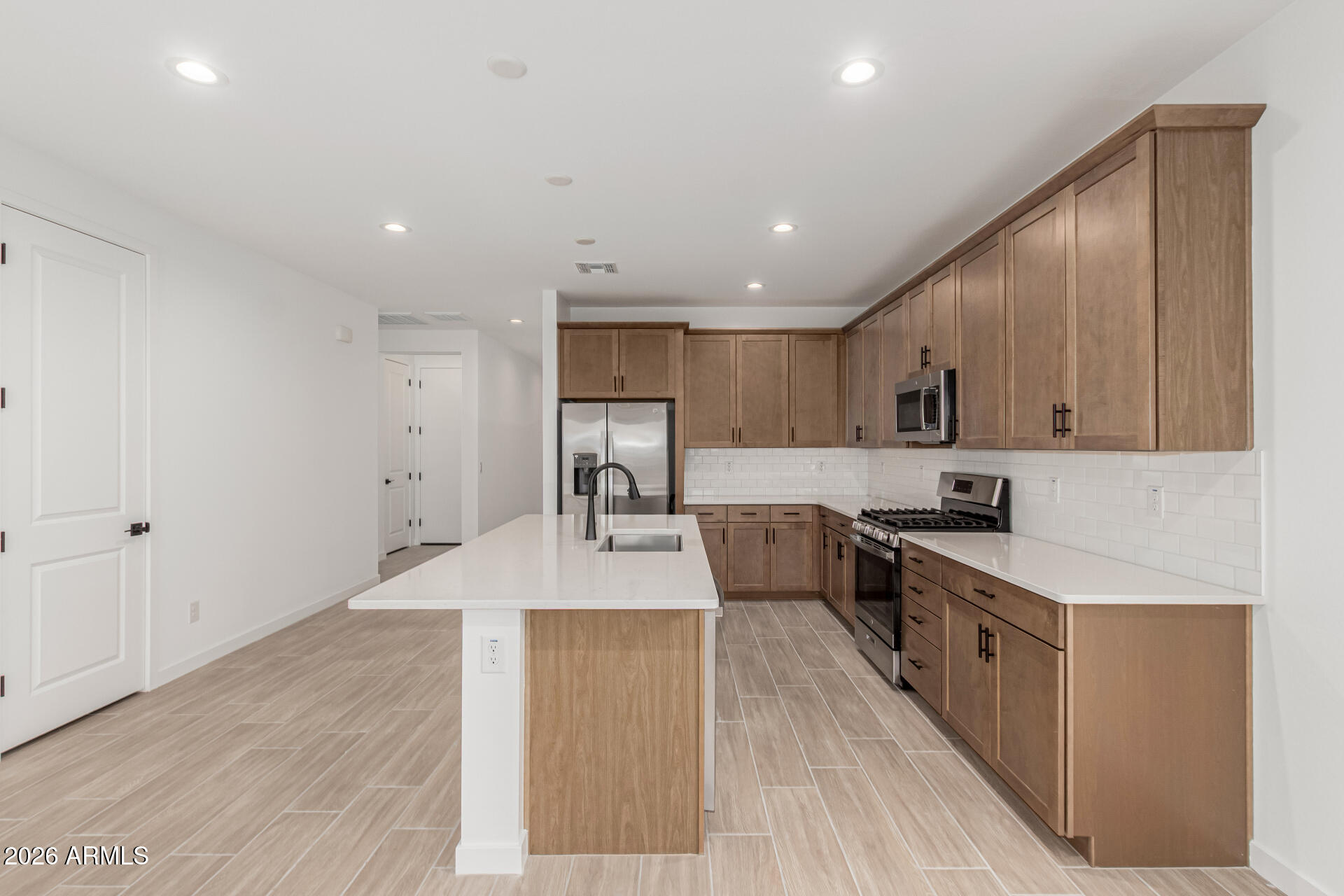 8029 West Granada Road Phoenix, AZ 85035 - Photo 4 of 35 a large kitchen with stainless steel appliances lots of counter space and wooden floor