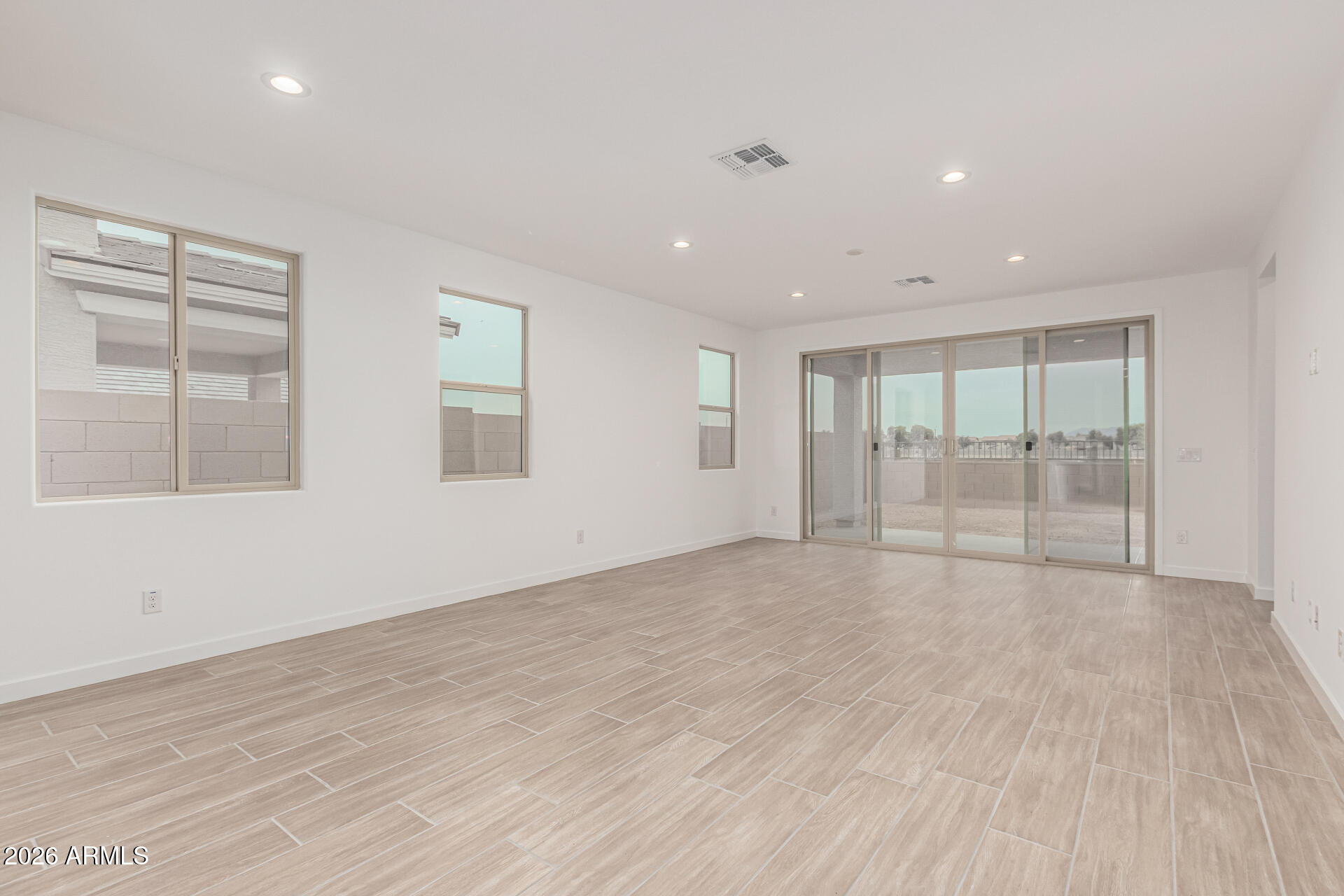 8029 West Granada Road Phoenix, AZ 85035 - Photo 7 of 35 a view of an empty room with wooden floor and a window