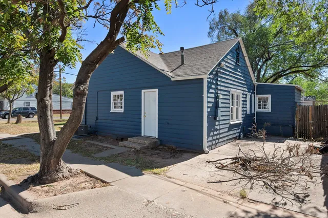 a wooden bench sitting in front of a house