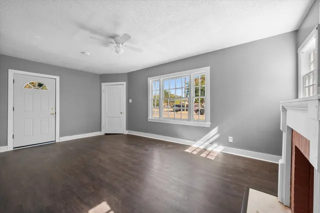 wooden floor in an empty room with a window