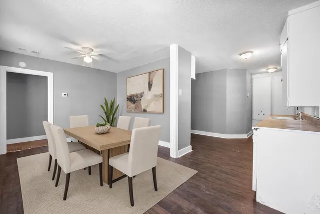a view of a dining room with furniture and wooden floor