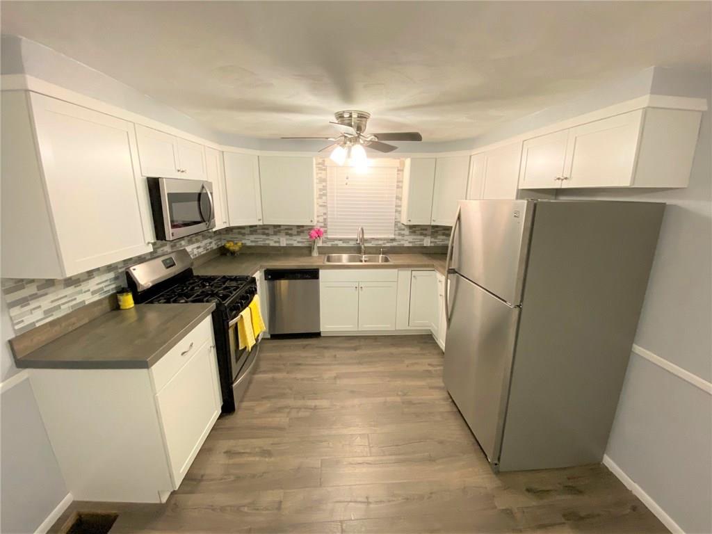 1029 Evergreen Road Pittsburgh, PA 15209 - Photo 8 of 25 Kitchen~ All new flooring,cabinetry, countertops and backsplash! All appliances stay!!!