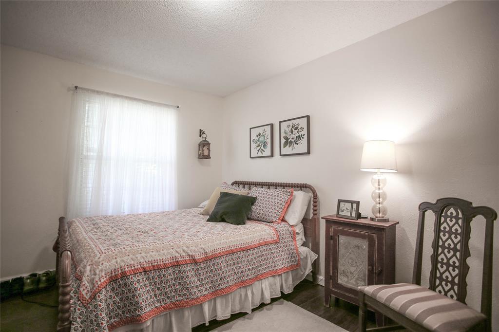 1720 Crystal Way Plano, TX 75074 - Photo 22 of 32 a bedroom with a bed and couch