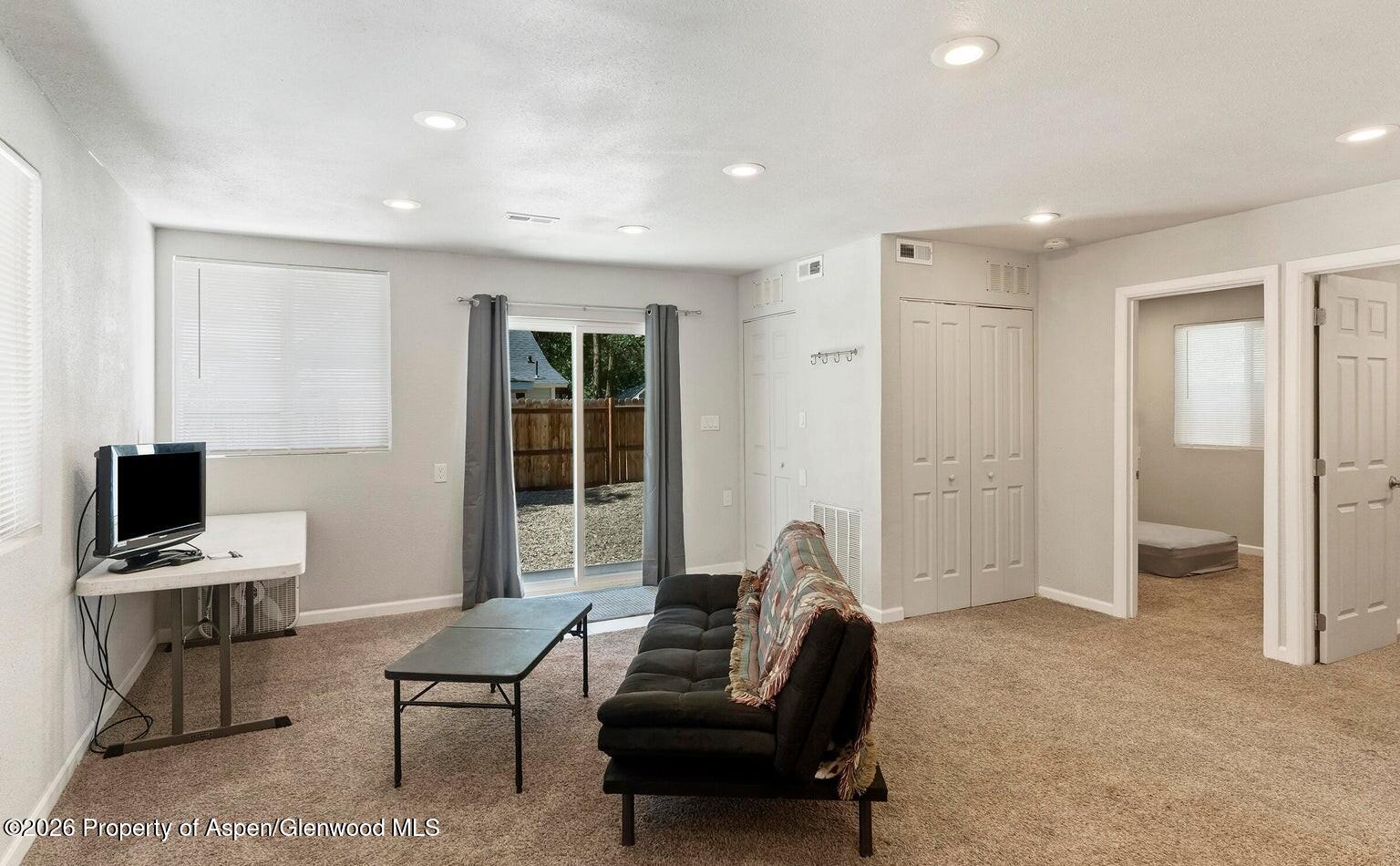 525 Colorado Street, Unit B Craig, CO 81625 - Photo 5 of 10 a living room with furniture and a flat screen tv